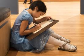 child draws in the galleries at the Nasher Museum