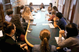 students talking around table