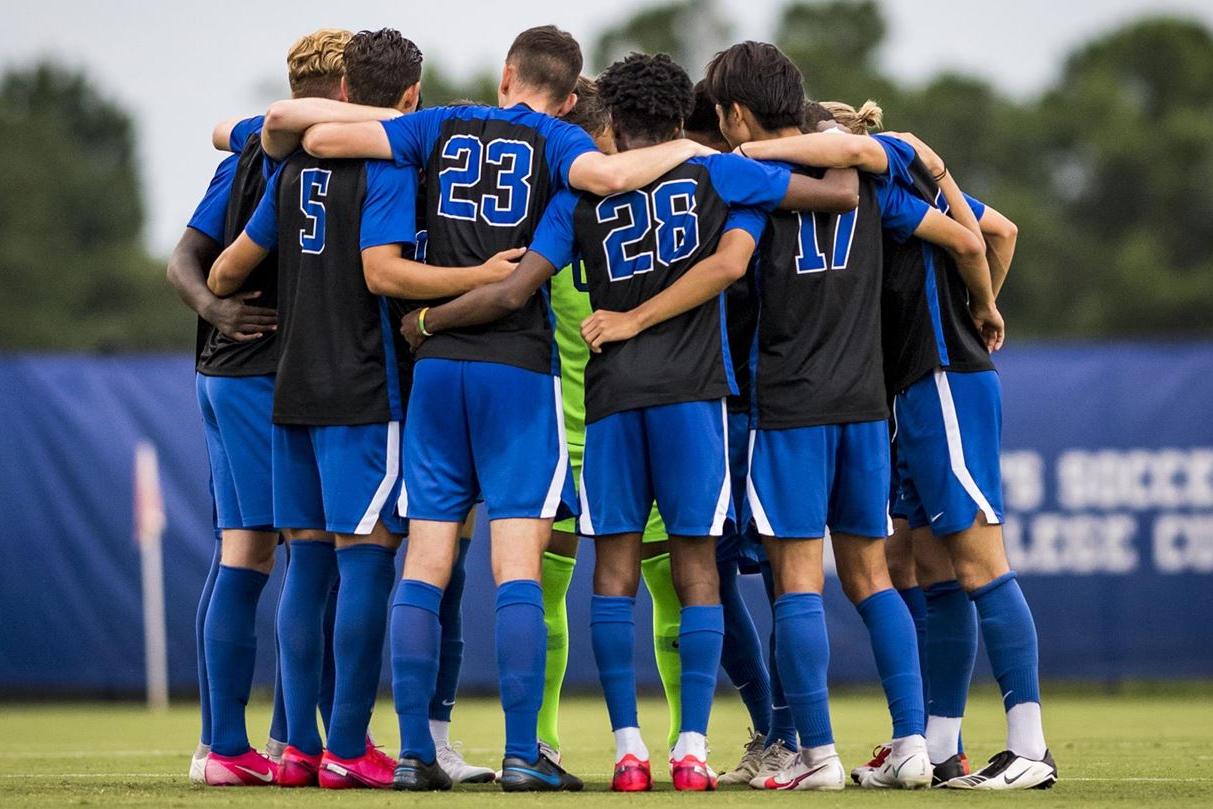 soccer players in huddle