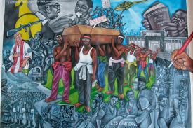 Art depicting conflict in Congo and casket being bourne