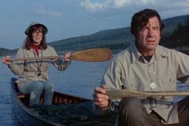 Elaine May and Walter Matthau paddling in a canoe on a river, in a scene from A NEW LEAF (1971)