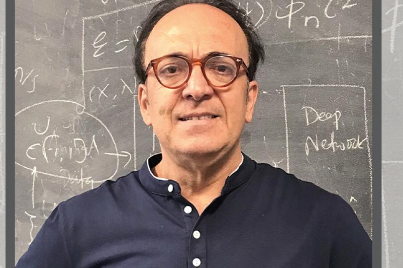 George Karniadakis in front of blackboard