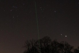 Image of laser pointer with spring stars over observatory