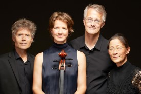 Ciompi Quartet standing against a black background by Alex Boerner