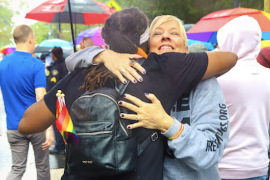 Two women, known as mama bears in the film, embrace during a street demonstration.