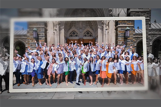 class of 2023 DPT students waiving to the camera, in their white coats in front of the Duke Chapel