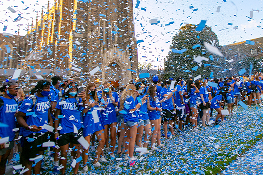 duke students in a shower of confetti in front of the Duke Chapel