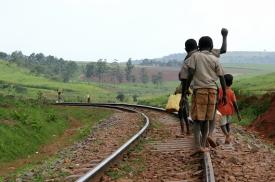 Children walking on railroad tracks in Africa