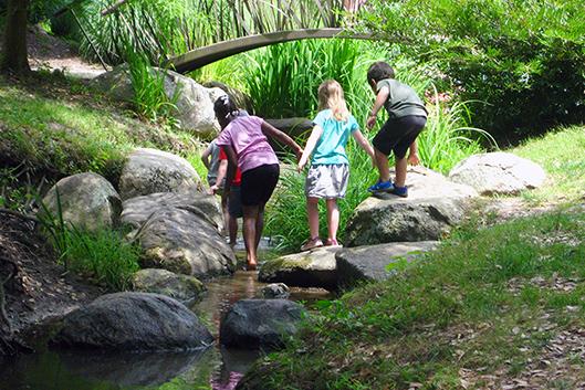 Children investigating the streams in Duke Gardens.
