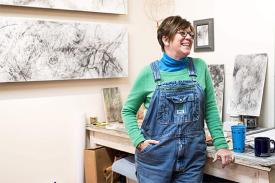Artist Kiki Farish in her studio in front of artwork.