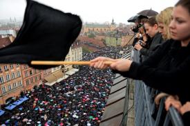 Women on balcony looking down on crowd and waving black flag Women on balcony looking down on crowd and waving black flag