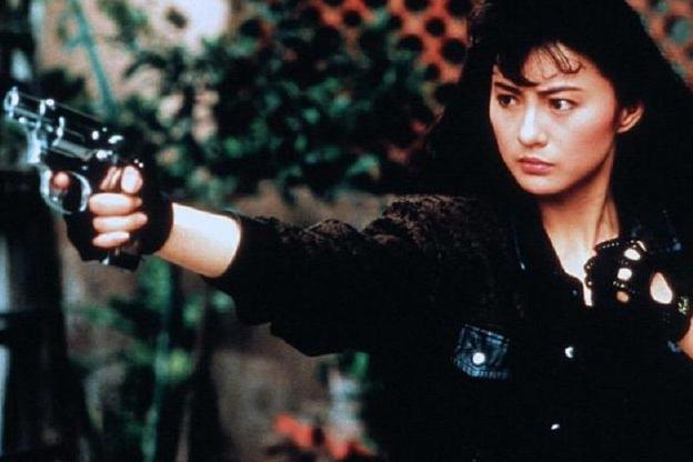 Actress wearing black and holding a pistol Actress wearing black and holding a pistol