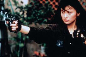 Actress wearing black and holding a pistol Actress wearing black and holding a pistol