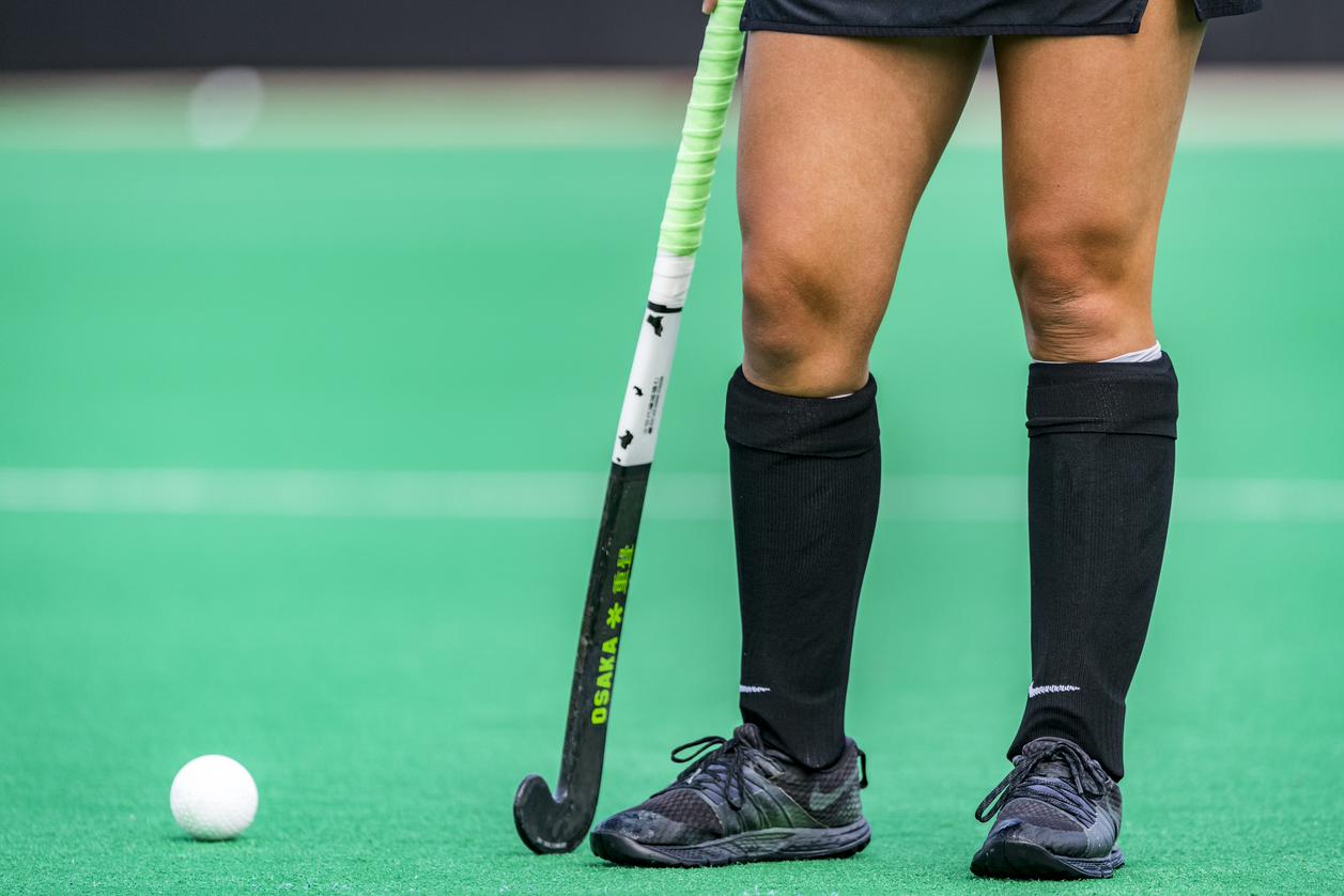 player holding hockey stick near ball