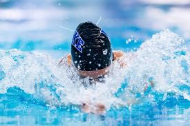 swimmer mid-stroke approaching camera