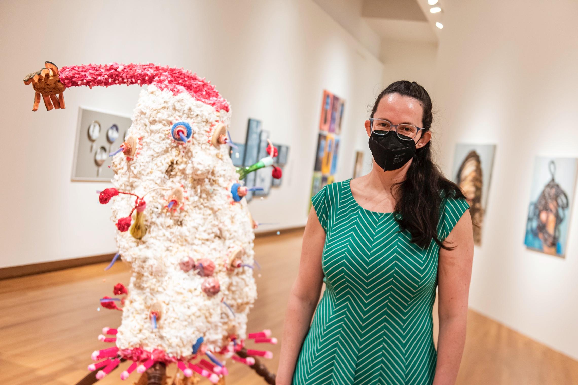 Artist Meg Stein poses with her sculpture