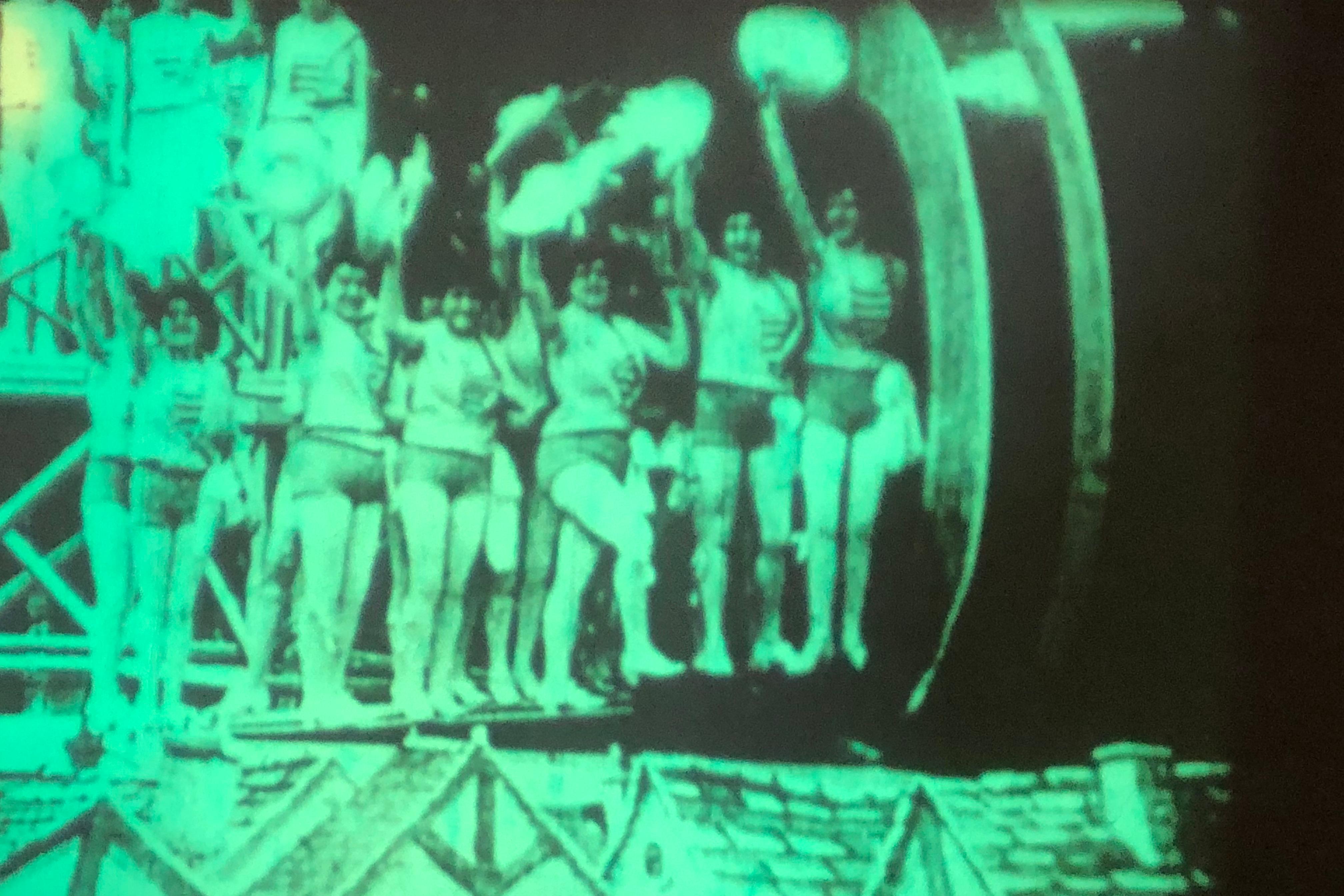 film still. women with green cast over the frame