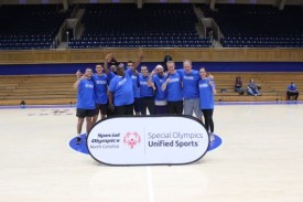 Duke Unified Basketball Championship team in Cameron Indoor Stadium with Special Olympics banner.