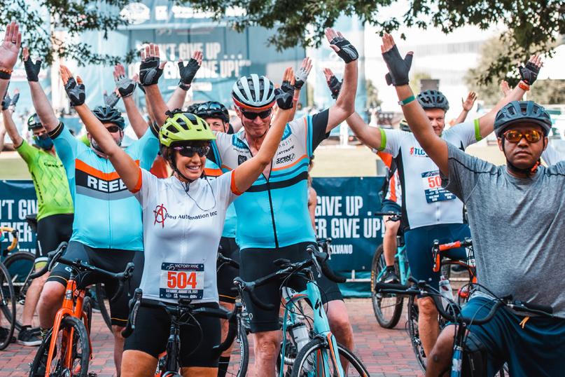 men and women on bikes with their hands in the air men and women on bikes with their hands in the air