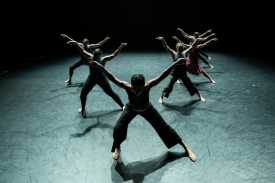 6 dancers form a V on stage.