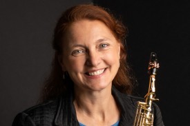 Headshot of Susan Fancher holding her saxophone