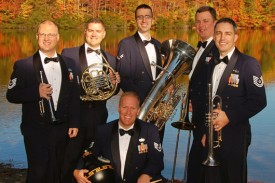Six airmen in the USAF Heritage Brass Ensemble with their instruments