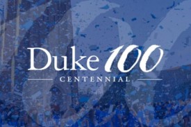 Students outside the Duke Chapel surrounded by confetti. Text overlay says, &quot;Duke 100 - Centennial&quot;