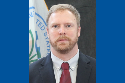 Seminar speaker, Dr. Joshua Harrill, standing in front of US EPA flag. Seminar speaker, Dr. Joshua Harrill, standing in front of US EPA flag.
