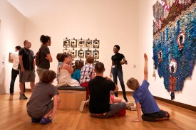 Gallery Guide Veronika Payne leads a discussion within the exhibition Love & Anarchy. Photo by Wilson.