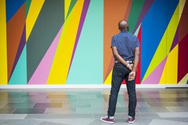 The artist Odili Donald Odita looks at this mural in the museum's Great Hall, "Shadow and Light (for Julian Francis Abele)."