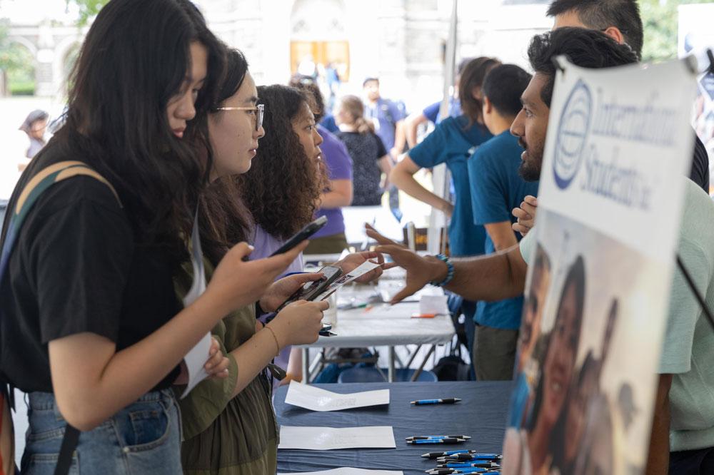 Students converse at a fair.