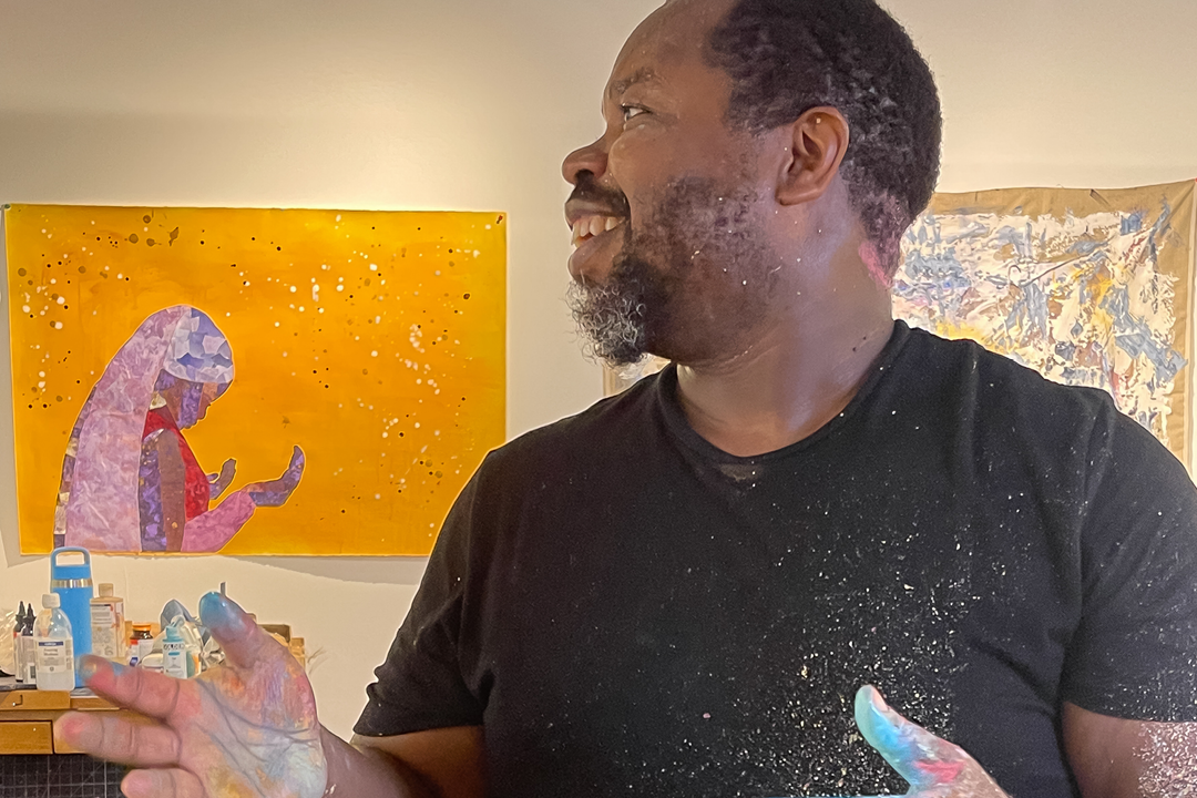 Artist Ashon Crawley with hands covered in paint