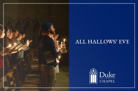 People hold candles in a darkened Duke Chapel.