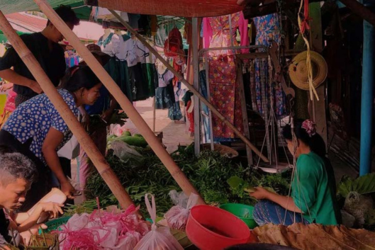 people shopping at an outdoor market