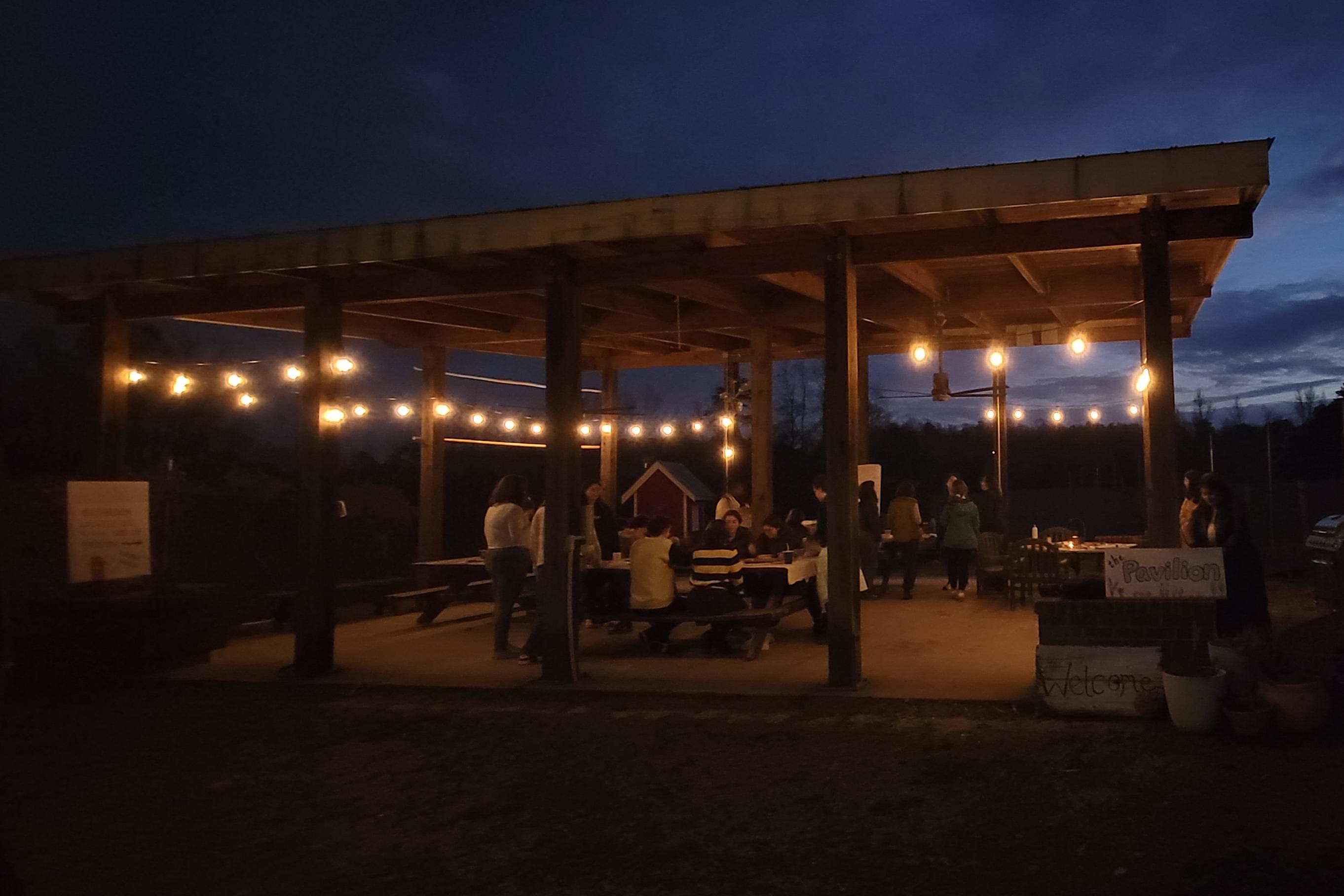 students under the pavilion at the duke campus farm for 2023 winterfest