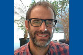 Seminar speaker, Mike Bergin, smiling and wearing black-framed glasses