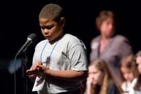 young student competing in spelling bee