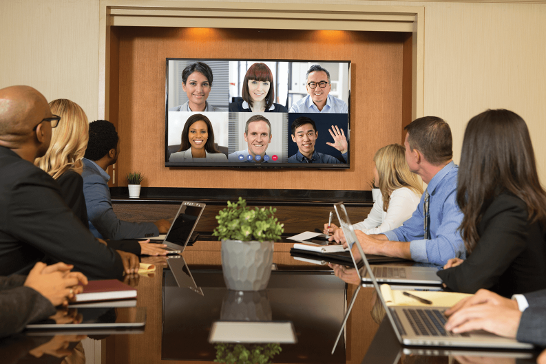 people attend a meeting in-person and virtually