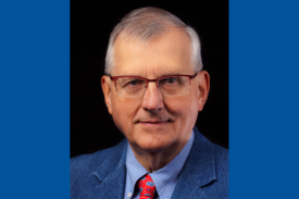 Seminar speaker, Dr. Randy Jirtle, wearing a blue suit jacket and red patterned tie.